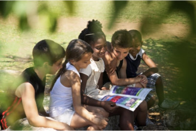 a group of children watching on a colorful page of a book