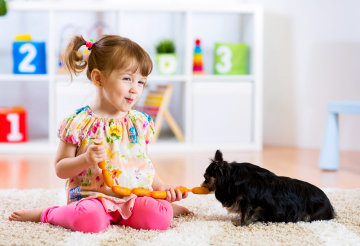 kid playing with her pet