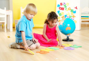 two kids playing with letters